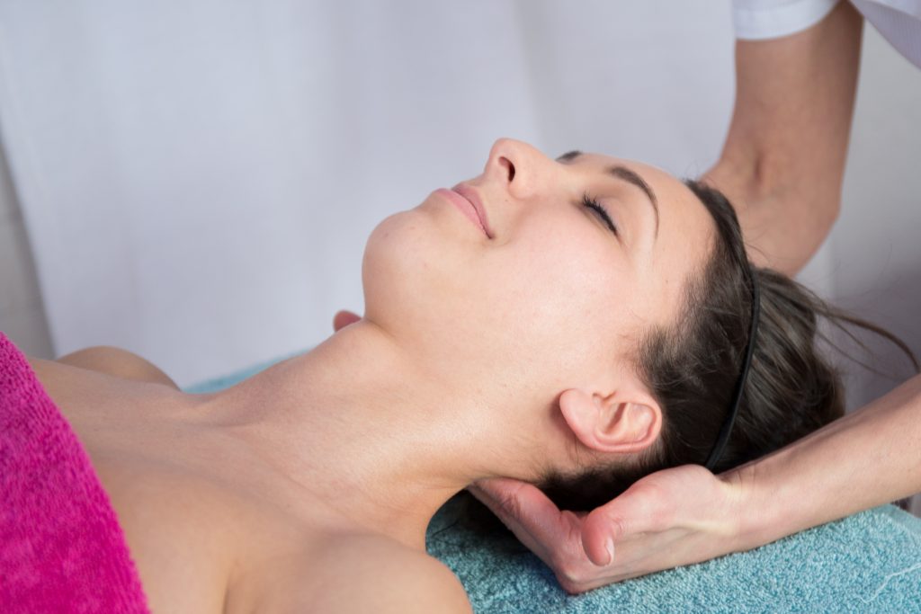 woman receiving massage therpay for neck pain relief