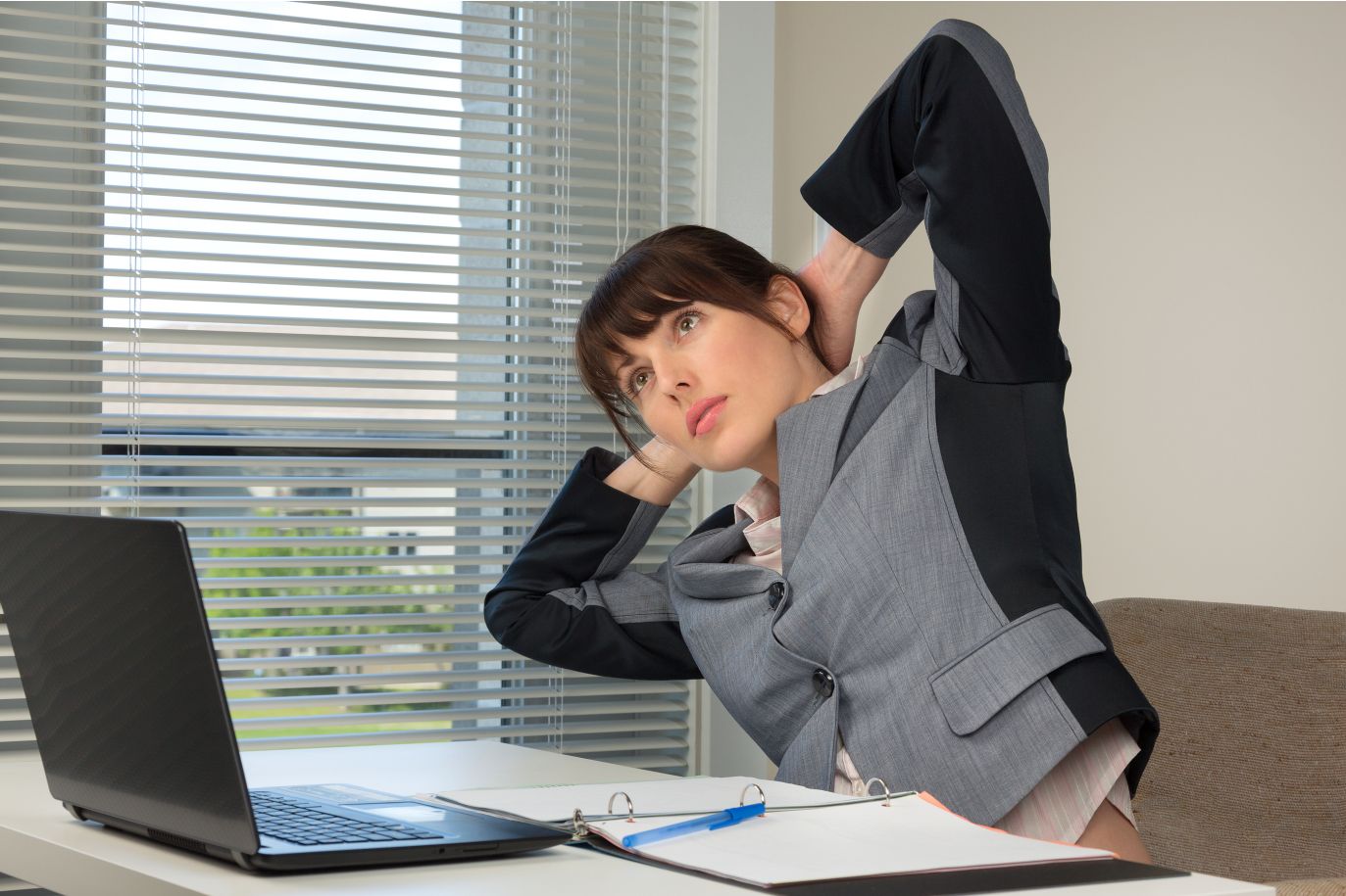 woman at desk doing exercises
