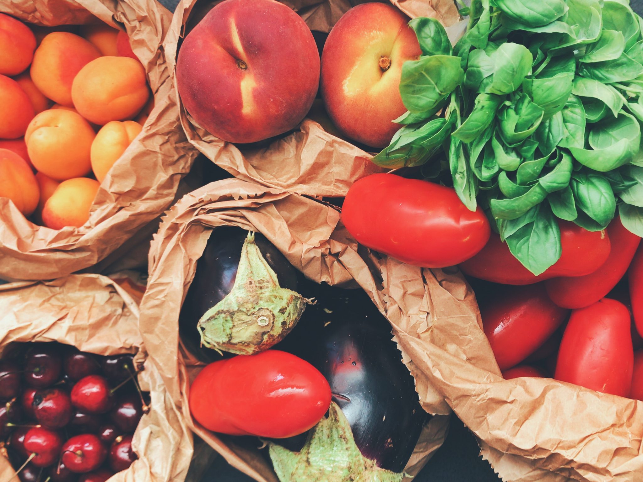 bags full of fresh healthy fruits and vegetables